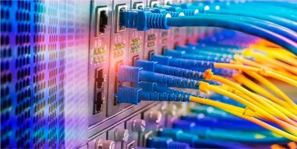 Fiber and copper patch cords terminated at a network switch in a data closet